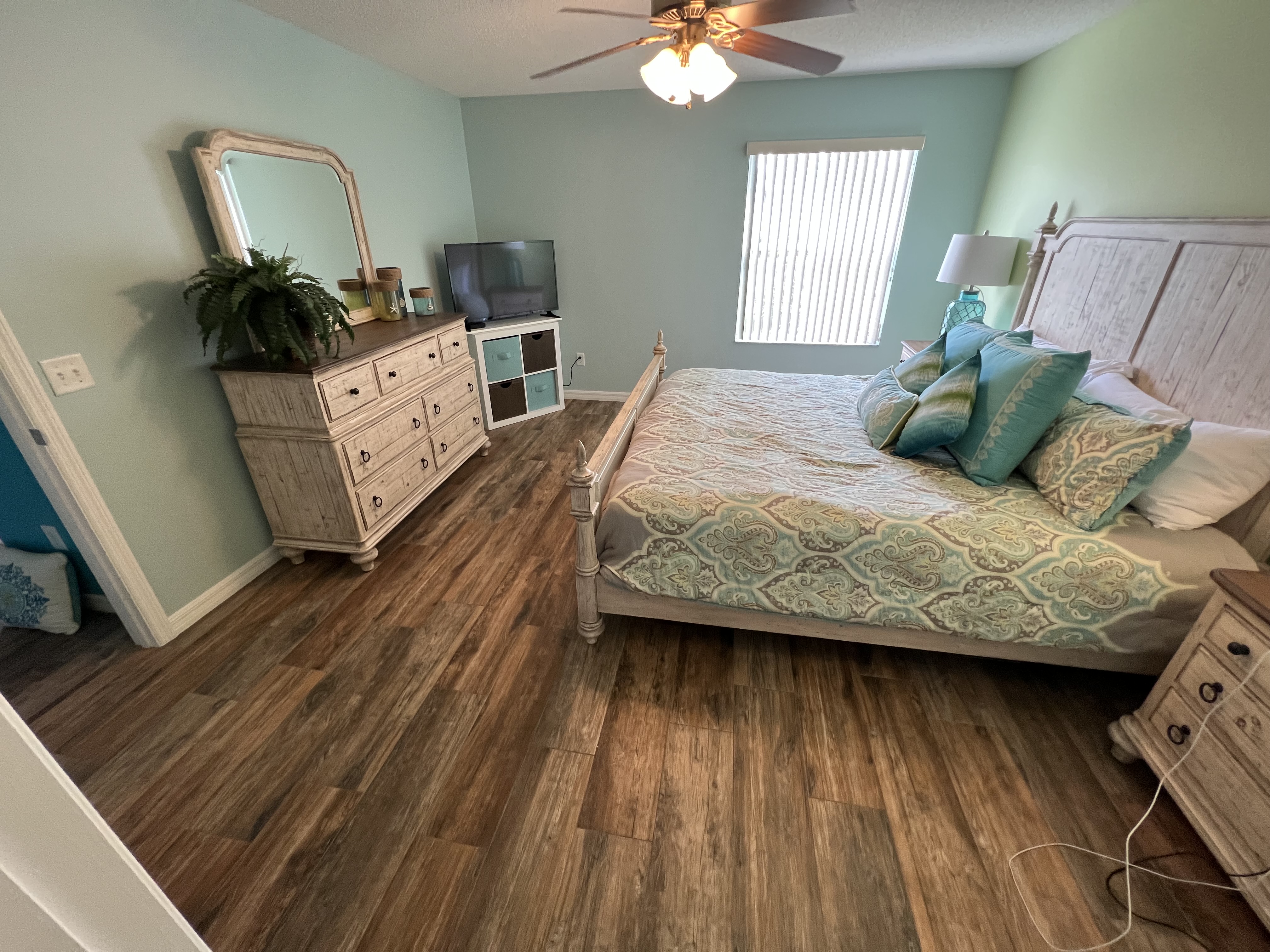 Master bedroom coastal decor with teal walls